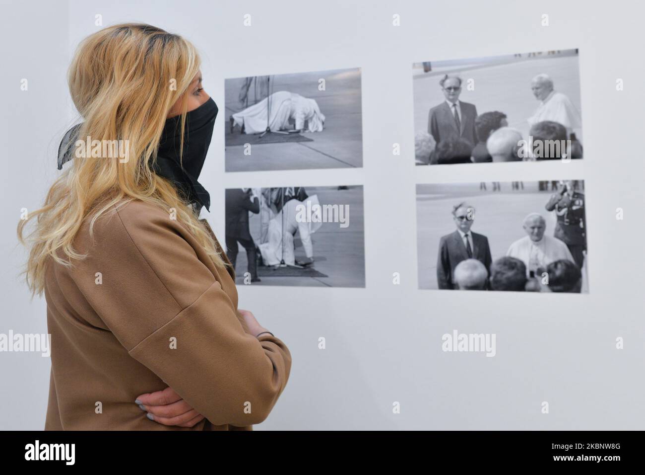 A lady looks a collection of historical pictures, a piece of art related to Jean Paul II, a part of 'The Pope' current exhibition of the Museum of Contemporary Art in Krakow MOCAK. On May 15, 2020, in Krakow, Poland. (Photo by Artur Widak/NurPhoto) Stock Photo