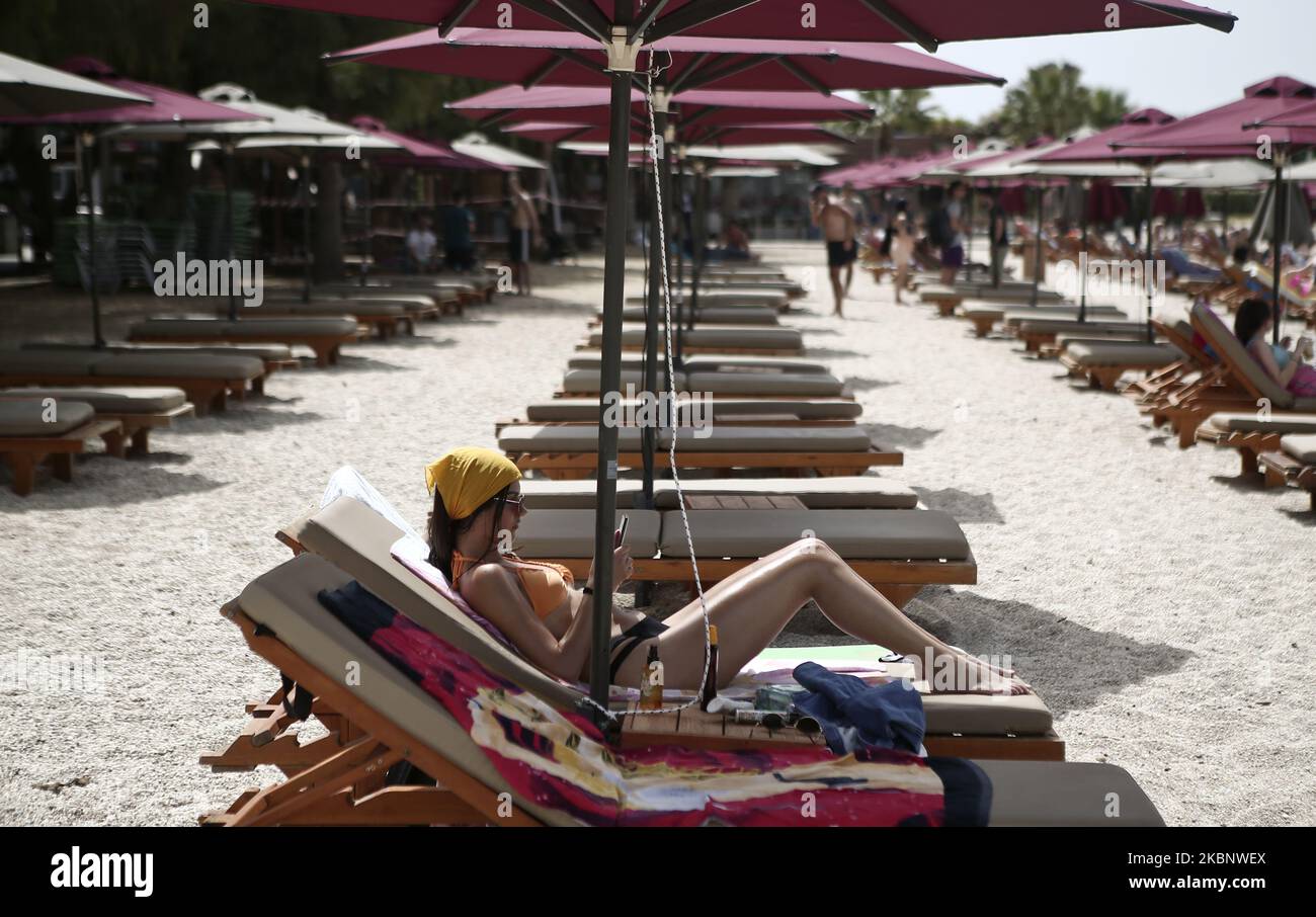People enjoy the beach at south suburbs of Athens, during the first day