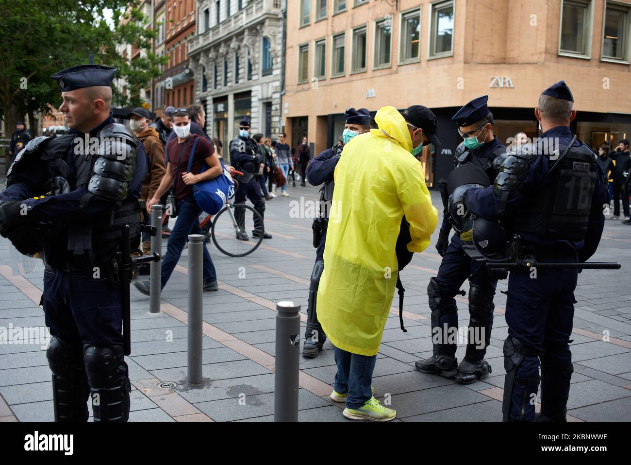 Riot policemen check the ID of a man supposed Yellow Vest, because he wears  a yellow coat in Toulouse, France, on May 16th 2020. As the lockdown in  France came to an
