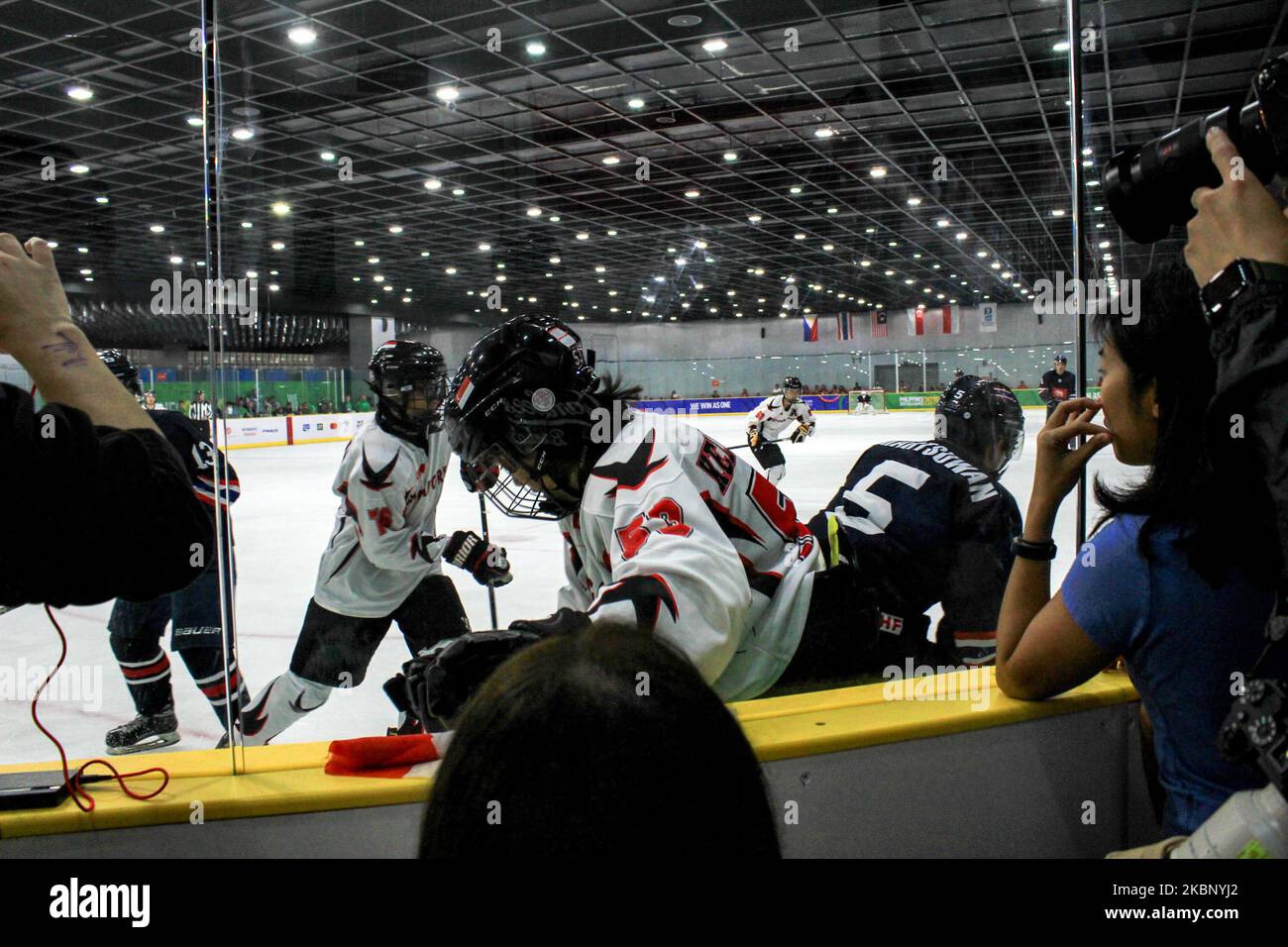 In this photo taken on 08 December 2019, hockey players compete for control of the puck during