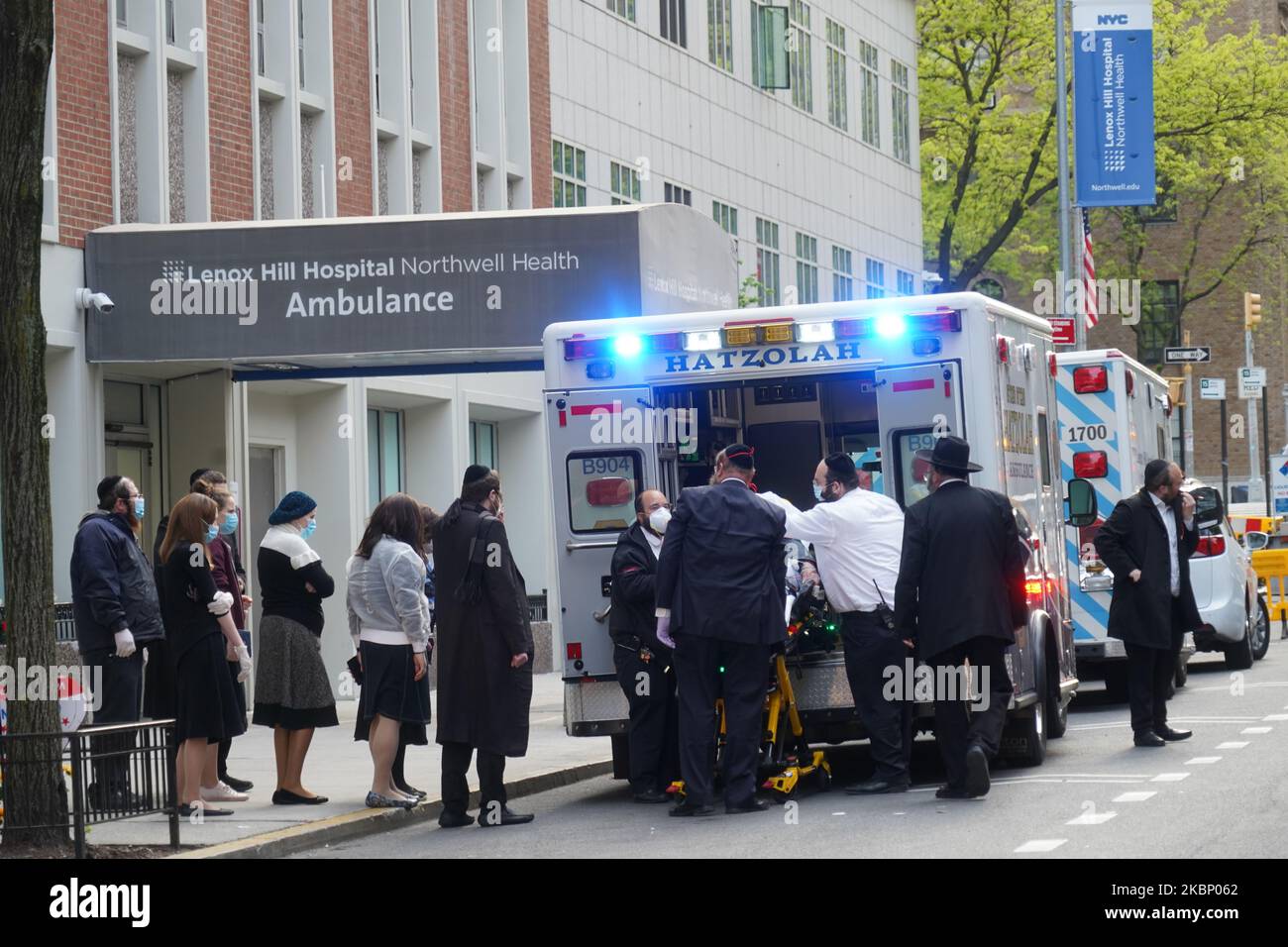 Emergency medical personnel transport a patient from an ambulance to