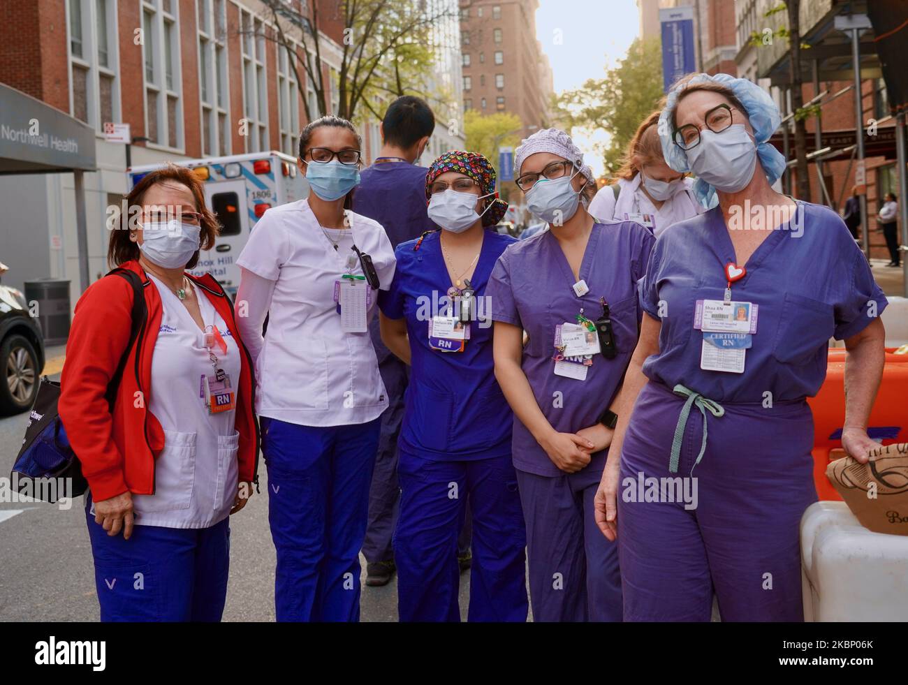 Nurses and healthcare workers at Lenox Hill Hospital pose outside the