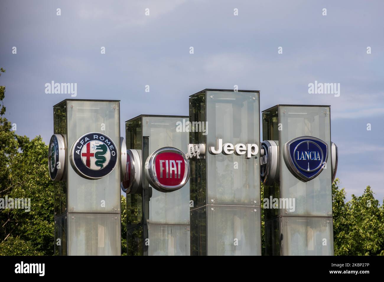 The logos of automobile companies (L-R) Alfa Romeo, Fiat, Jeep, Lancia are pictured at the entrance to the Fiat Chrysler Automobiles (FCA) at the Fiat Mirafiori car plant on in Turin, Italy on 19th May 2020. FCA's Italian loan request as part of more than 400 billion euros Italy is making available to businesses hit by the pandemic, raises criticism within the ruling Italian coalition. The reason is a possible payment of a large dividend to FCA's investors at a time when the coronavirus crisis has left cash-starved manufacturers. (Photo by Mauro Ujetto/NurPhoto) Stock Photo