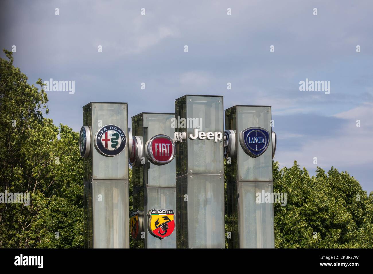 The logos of automobile companies (L-R) (L-R) Alfa Romeo, Fiat, Jeep, Lancia and Abarth (bottom) are pictured at the entrance to the Fiat Chrysler Automobiles (FCA) at the Fiat Mirafiori car plant on in Turin, Italy on 19th May 2020. FCA's Italian loan request as part of more than 400 billion euros Italy is making available to businesses hit by the pandemic, raises criticism within the ruling Italian coalition. The reason is a possible payment of a large dividend to FCA's investors at a time when the coronavirus crisis has left cash-starved manufacturers. (Photo by Mauro Ujetto/NurPhoto) Stock Photo