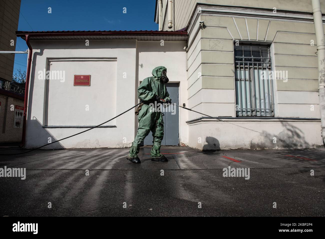 A Russian serviceman sprays disinfectant at the yard of the recruitment center, St. Petersburg, on May 20, 2020. President Vladimir Putin declared a send to the army of 135,000 people during the spring call-up in Russia which started on the 20th of May. All recruits tested for Covid-19 infection, will be quarantined for 14 days in their military units. (Photo by Sergey Nikolaev/NurPhoto) Stock Photo