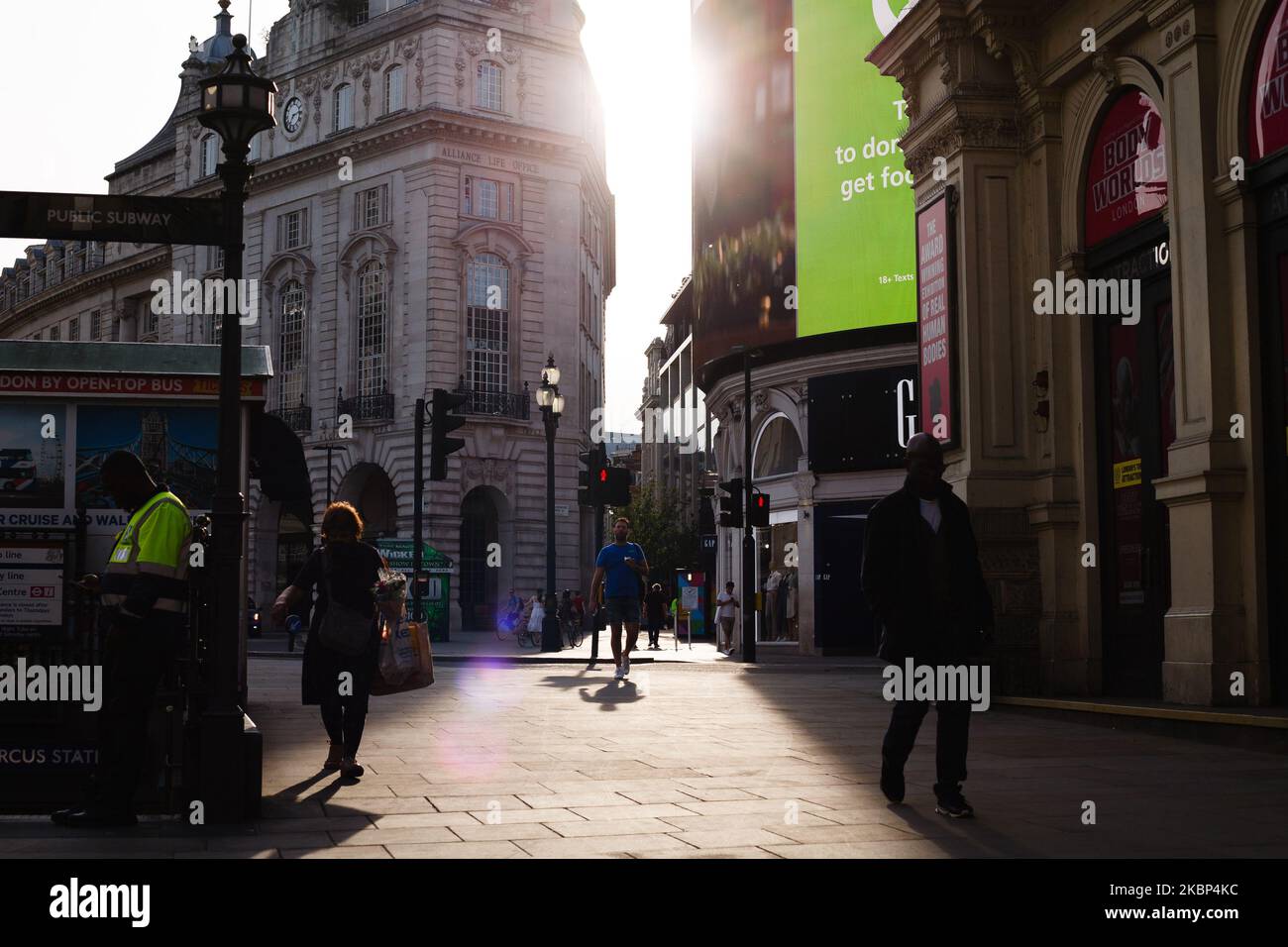 People walk through a near-deserted Piccadilly Circus in London, England, on May 21, 2020. Coronavirus cases are believed to be dropping to very low levels across the capital, with none at all recorded this Monday, according to data from Public Health England, and media reporting yesterday that six major London hospitals had recorded no covid-19 deaths for the previous 48 hours. UK-wide deaths meanwhile stand at 36,042 according to the daily total released this afternoon by the Department of Health and Social Care. (Photo by David Cliff/NurPhoto) Stock Photo