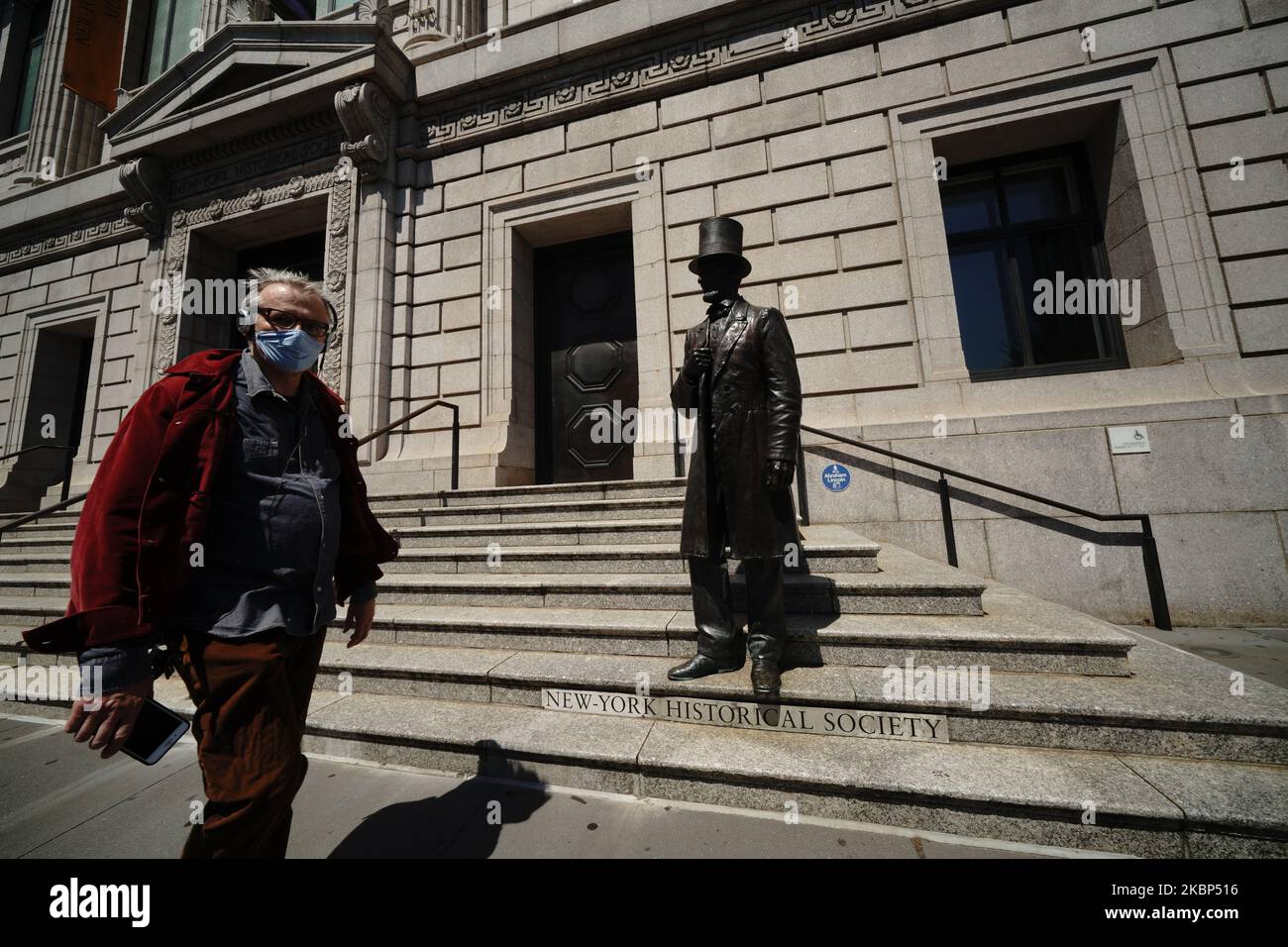 A view of a person wearing a mask outside New York Historical Museum during the coronavirus pandemic on May 20, 2020 in New York City. COVID-19 has spread to most countries around the world, claiming over 316,000 lives with over 4.8 million infections reported. (Photo by John Nacion/NurPhoto) Stock Photo