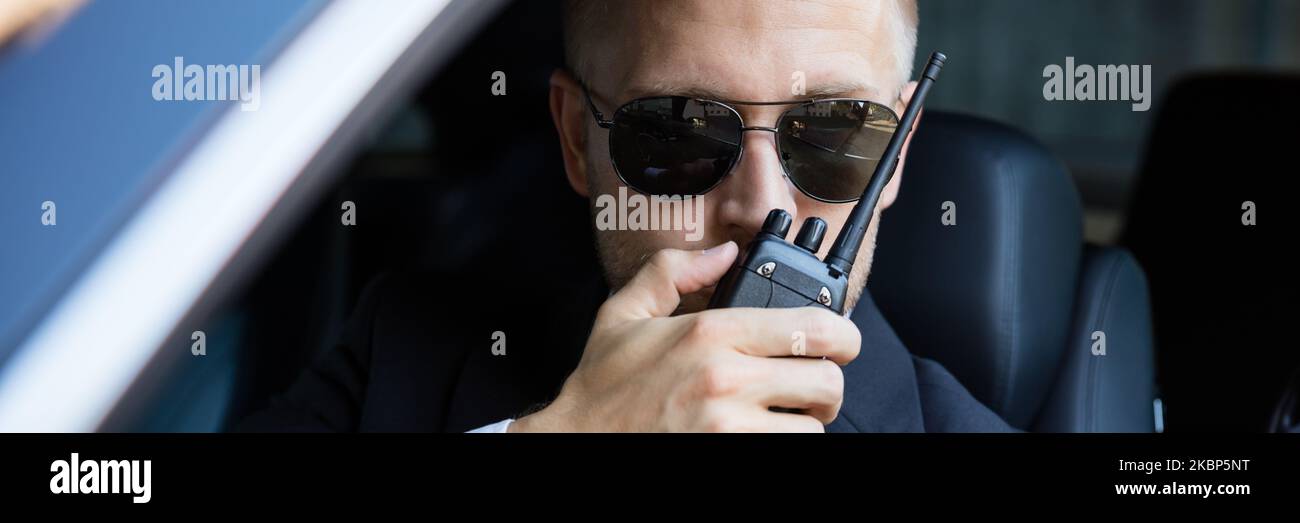 Security Detective Man In Car. Investigator With Walkie Talkie Stock Photo