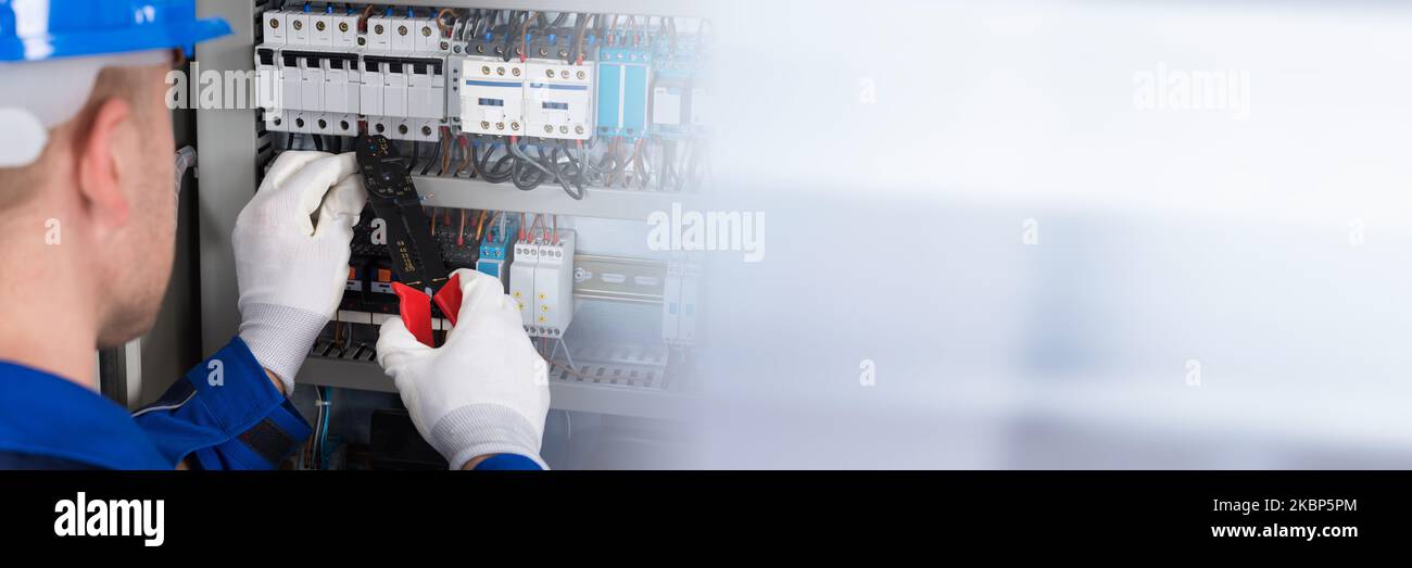 Electrician Worker Repair And Installation Of Control Box Stock Photo