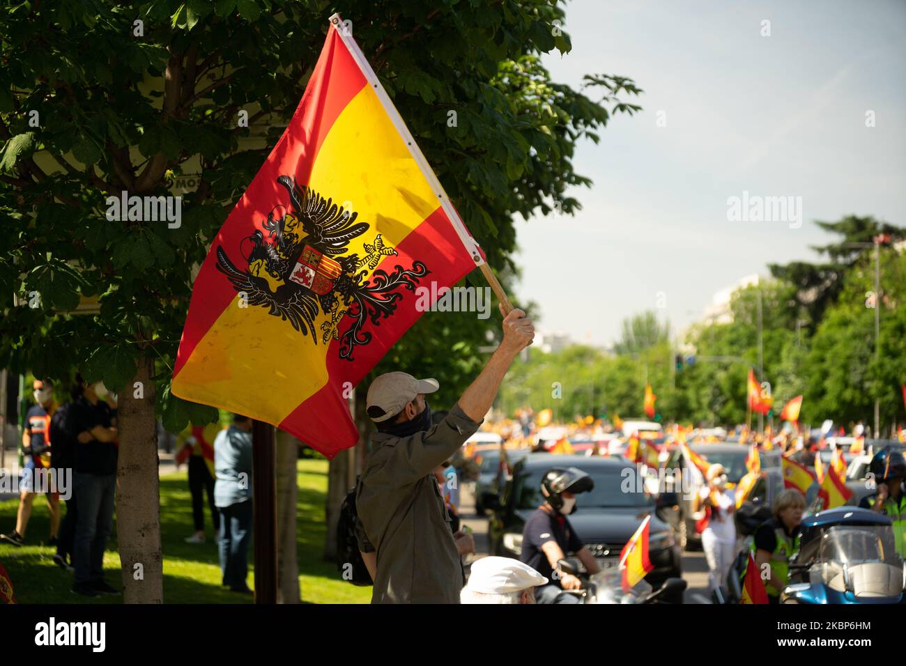 A man with the Francoist flag in the ''Caravan for Spain and its Freedom'' that has been held in the streets of Madrid and other provincial capitals on May 23, 2020 in Madrid, Spain. (Photo by Jon Imanol Reino/NurPhoto) Stock Photo