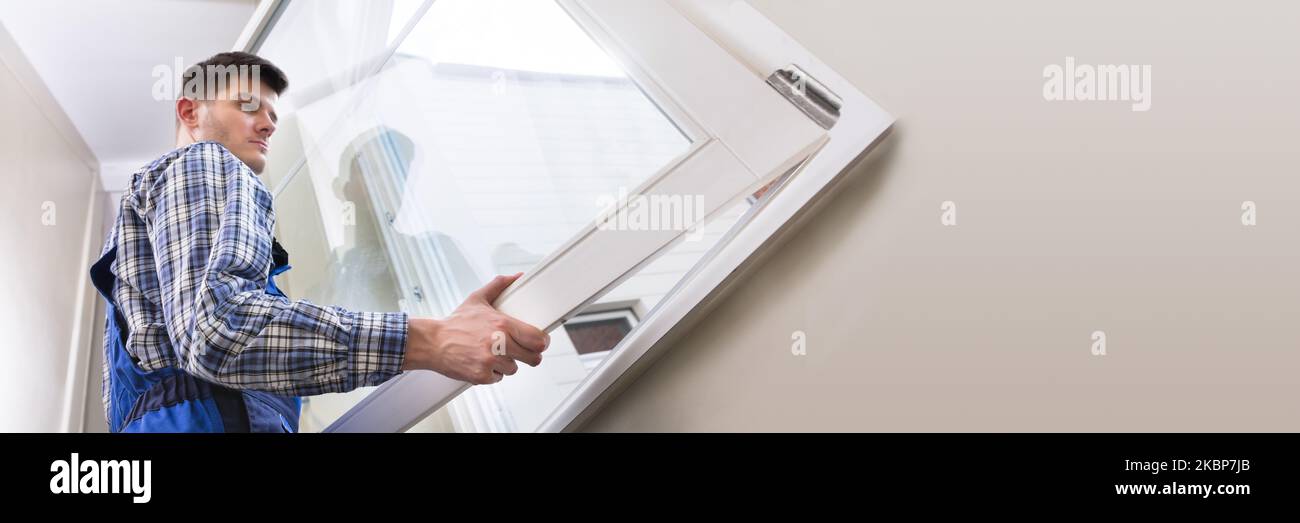 Window Install Service. Man Installing And Fixing House Stock Photo - Alamy