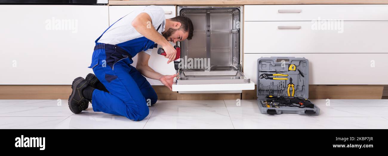 Dishwasher Repair. Washer Appliance Install In Kitchen Stock Photo Alamy