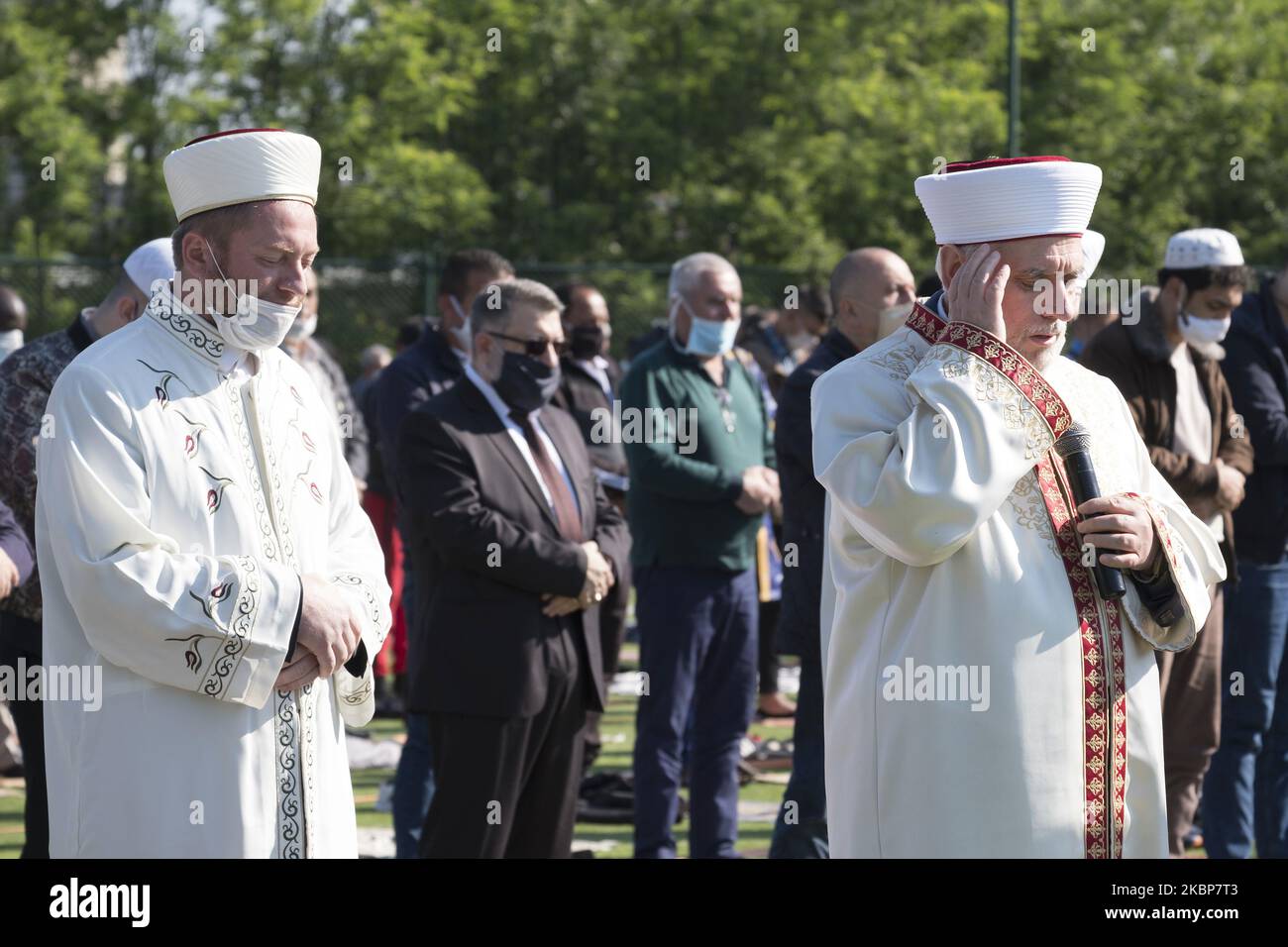Dr. Mustafa Hadzhi, Grand Mufti of Bulgaria, leads prayers for hundreds of Muslims gathered to celebrate Eid al-Fitr on a soccer field at Lokomotiv Stadium in Sofia, Bulgaria on May 24, 2020. Due to the coronavirus restrictions, the central mosque is closed. Participants came from many different countries and the sermon was given in Bulgarian, Turkish and Arabic. (Photo by Jodi Hilton/NurPhoto) Stock Photo