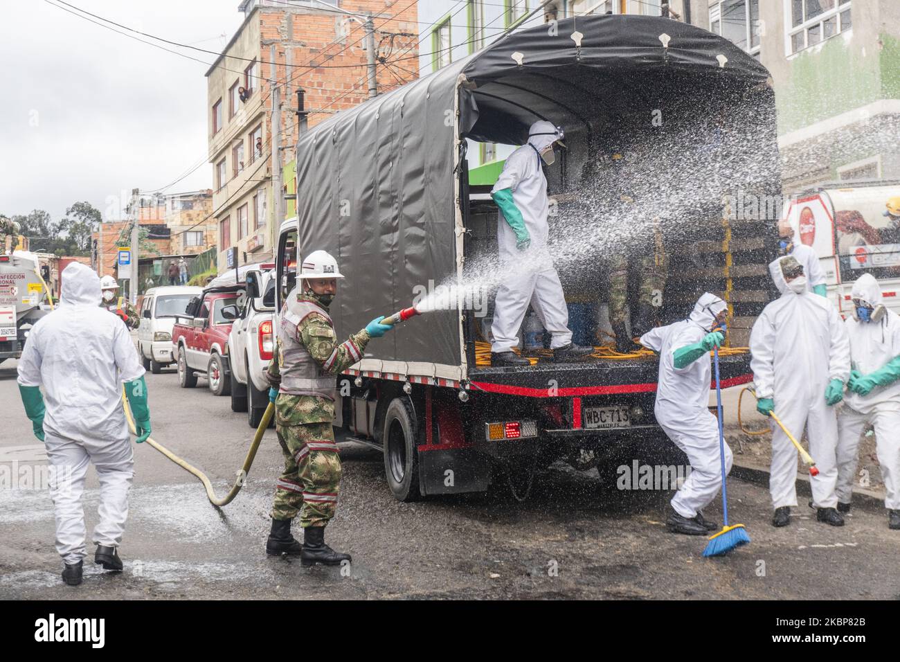 Soldiers from the Military Police Battalion during a cleaning, disinfection and spraying session in the La Mariposa Mariposa sector to counter the spread of the corona virus, COVID 19 on May 23, 2020 in Bogota, Colombia. (Photo by Daniel Garzon Herazo/NurPhoto) Stock Photo