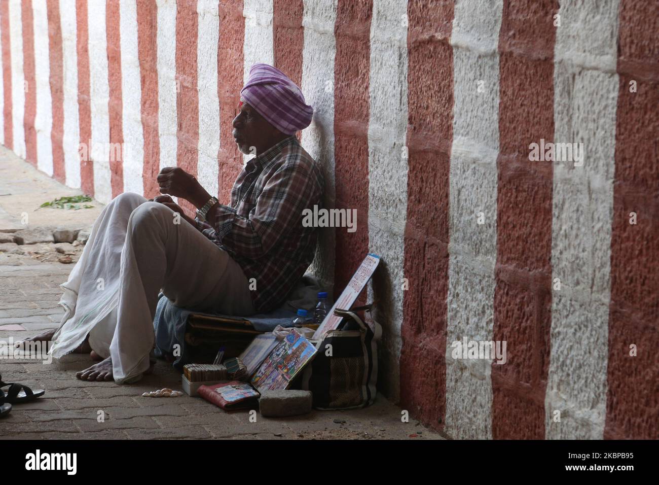 Hindu fortune teller and palmist sits outside the Kanyakumari Devi