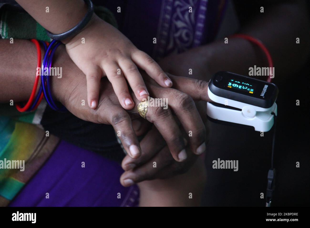 A pulse oximeter is placed on the hand of a resident during a medical check-up in the Dharavi slum area of Mumbai, India on May 29, 2020. India continues in nationwide lockdown to control the spread of the Coronavirus (COVID-19) pandemic. (Photo by Himanshu Bhatt/NurPhoto) Stock Photo