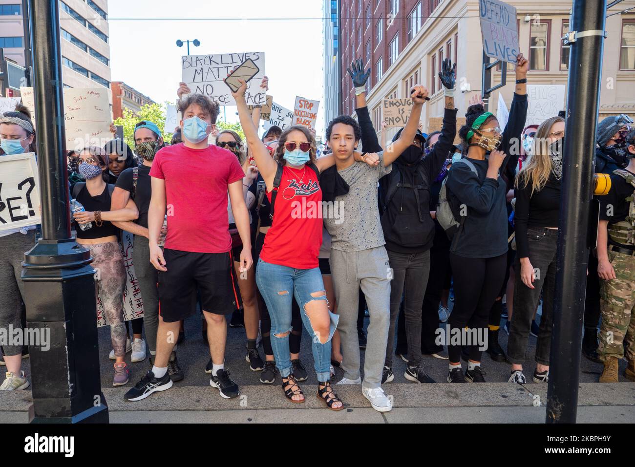 Demonstrators raise their arms during a stand-off with the Hamilton County Sheriff’s Department at the Courthouse during a protest of the death of George Floyd, Sunday, May 31, 2020, in Cincinnati, Ohio, United States. (Photo by Jason Whitman/NurPhoto) Stock Photo