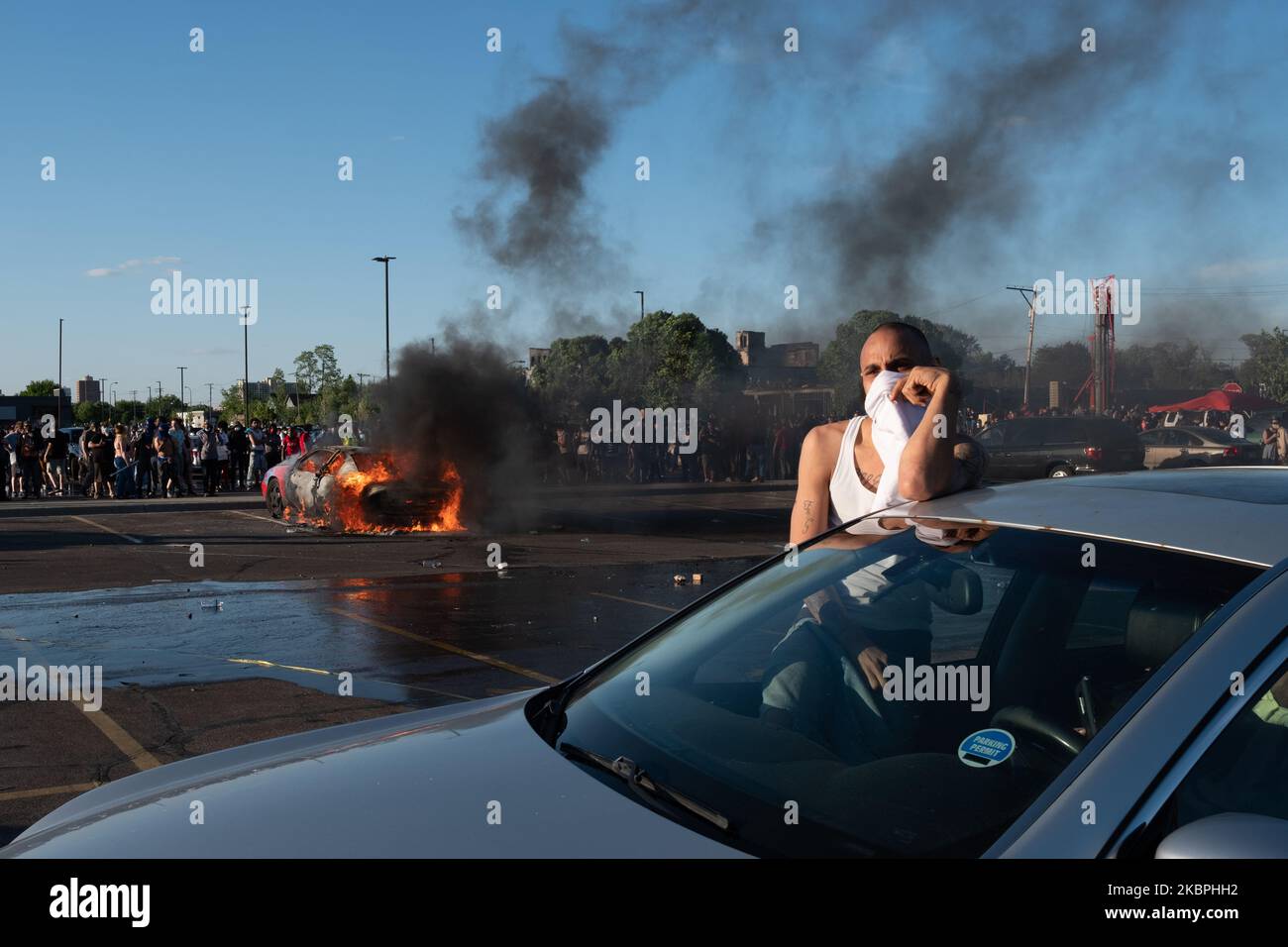 A car burns in a Target branch parking lot across from Minneapolis's