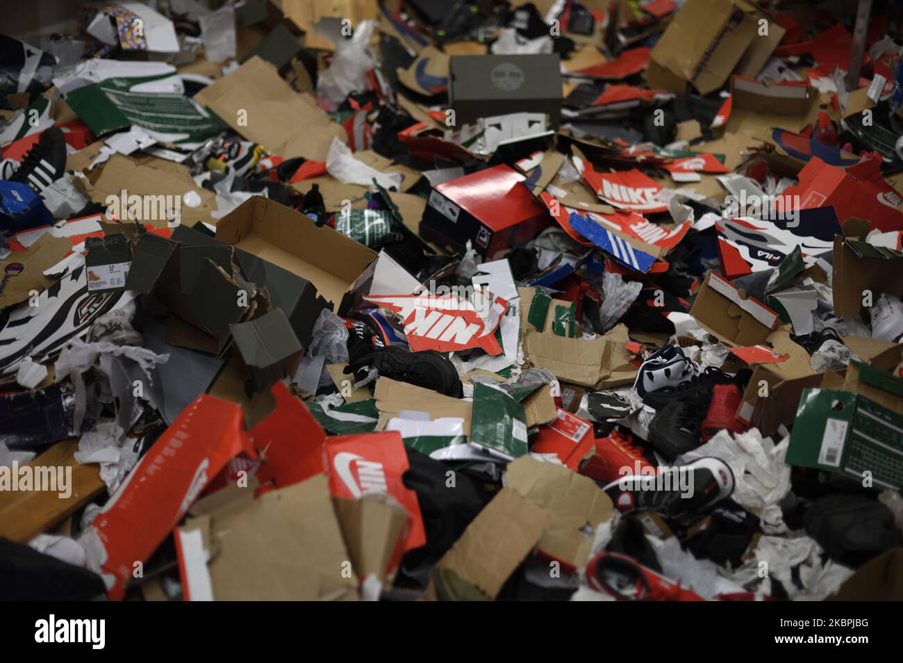 Empty shoe boxes are left on the ground in the storage room of a ...