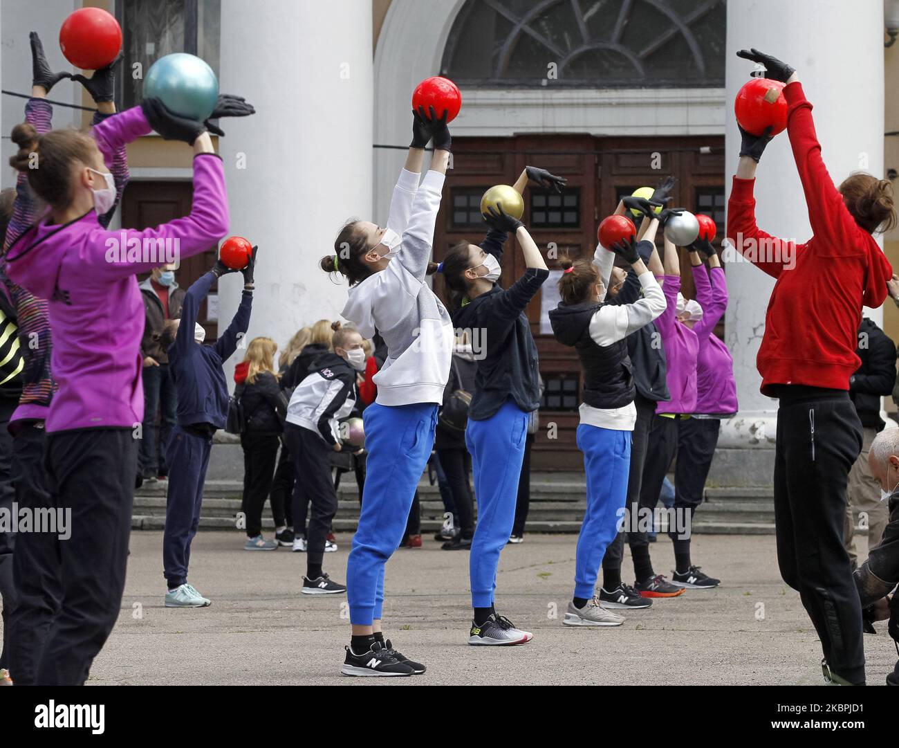 Gymnasts of the Deriugina School wearing protective masks amid the Covid-19 coronavirus epidemic take part at a trainning session in central Kyiv, Ukraine, on 01 June, 2020. Young gymnasts had a training on a street to support the 'Save Deriugina School' action, which was organized in support of Irina Deryugina children's and youth sports school of gymnastics. (Photo by STR/NurPhoto) Stock Photo