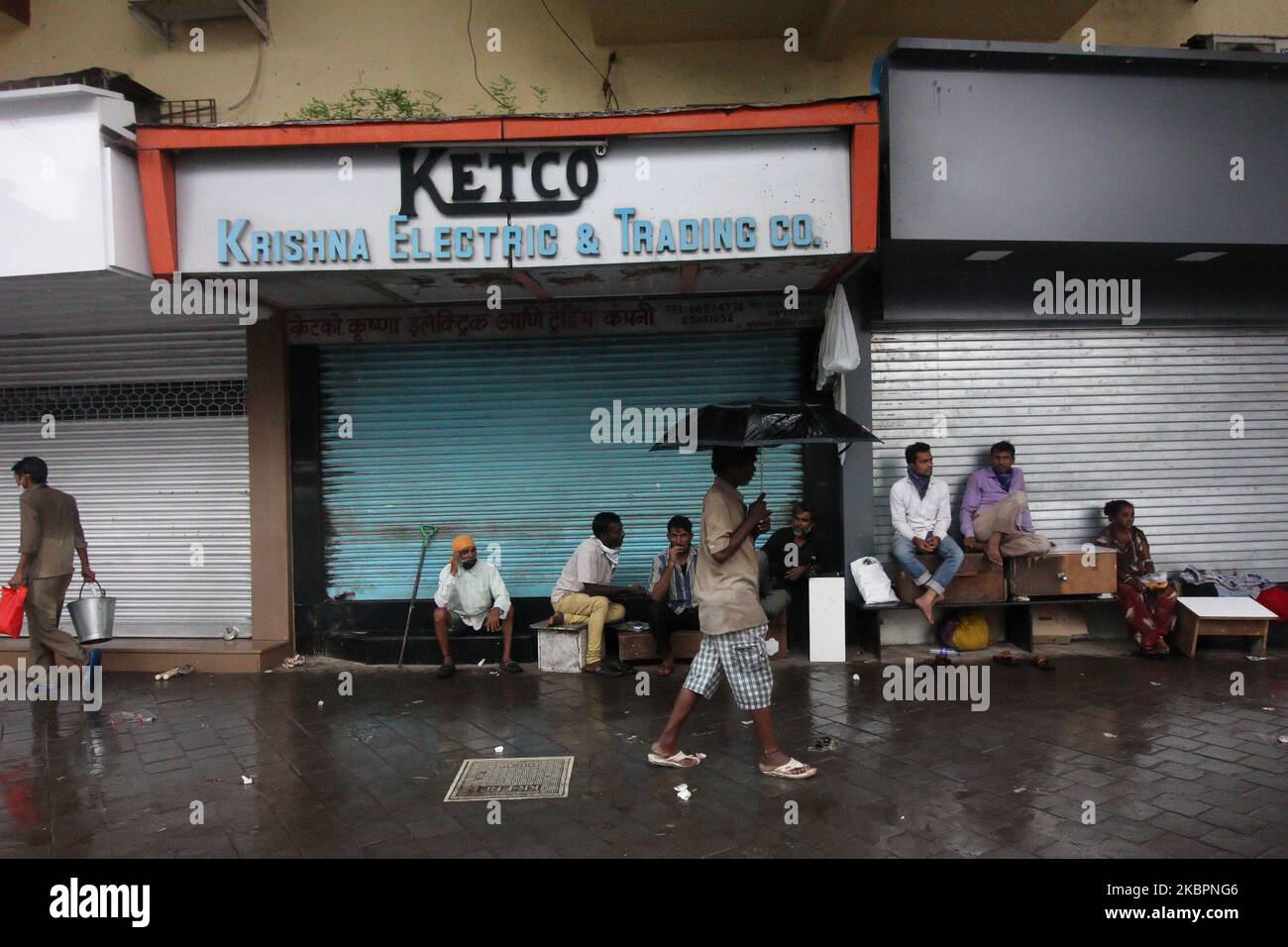People take shelter from rain in Mumbai, India on June 03, 2020