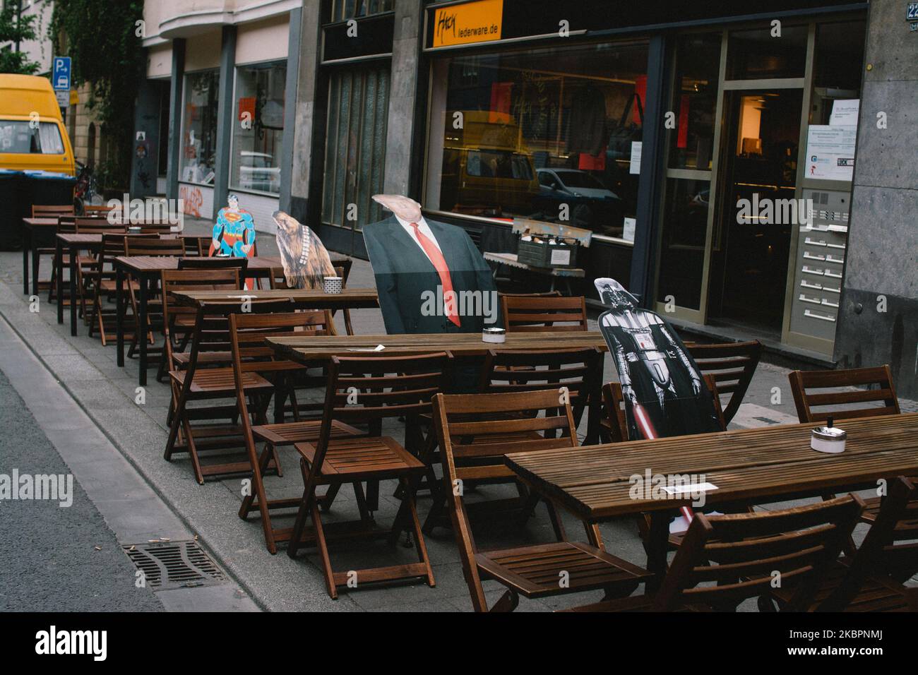 Cardboard cutouts of trump and other film figures sat in between the seats outside of a cafe which helps diners feel social distance, in Leverkusen, Germany, on June 3, 2020. (Photo by Ying Tang/NurPhoto) Stock Photo