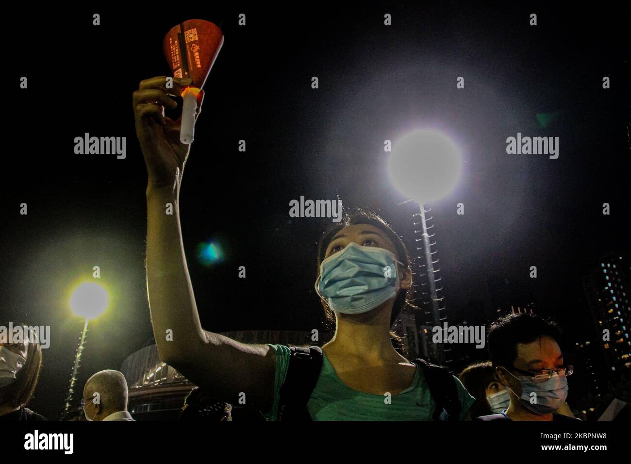 A resident holds up a candle to mark 31 years since the Tiananmen