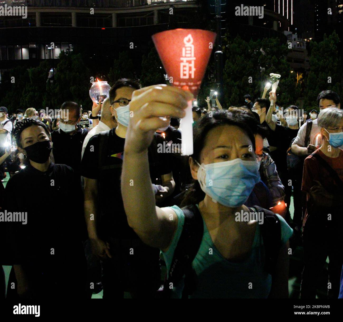 A resident holds up a candle to mark 31 years since the Tiananmen