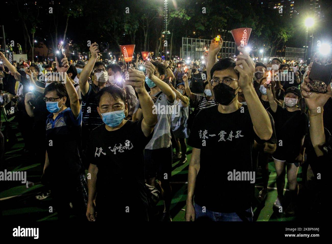 Prodemocracy politician Avery Ng leads a singing crowd whilst holding