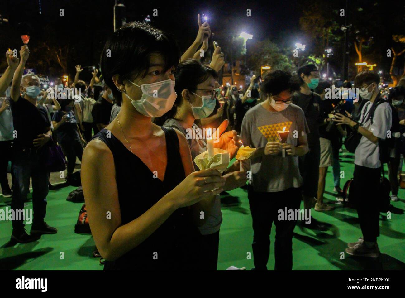 A resident holds up a candle to mark 31 years since the Tiananmen