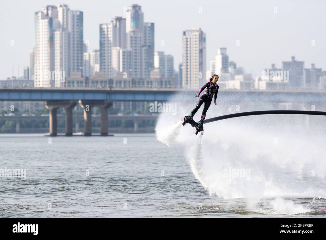 Flyboarding World Champion Park Jin-min gives a demonstration on Yeouido Hangang River Park on June 05, 2020 in Seoul, South Korea. since 2011 flyboarding is a new extreme watersport allowing the pilot to fly high above the water. This is made possible by a water propulsion system that is attached with a tube to the feet and connected to a water scooter with a high pressure water pump on a board. (Photo by Chris Jung/NurPhoto) Stock Photo