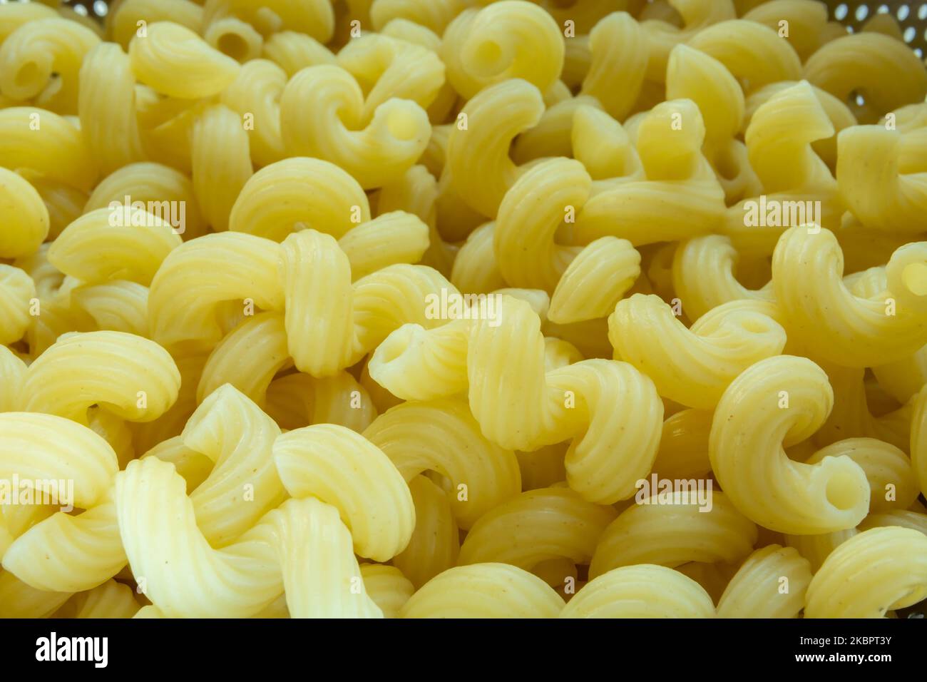 Close up of yellow gimlet pasta, top view Stock Photo