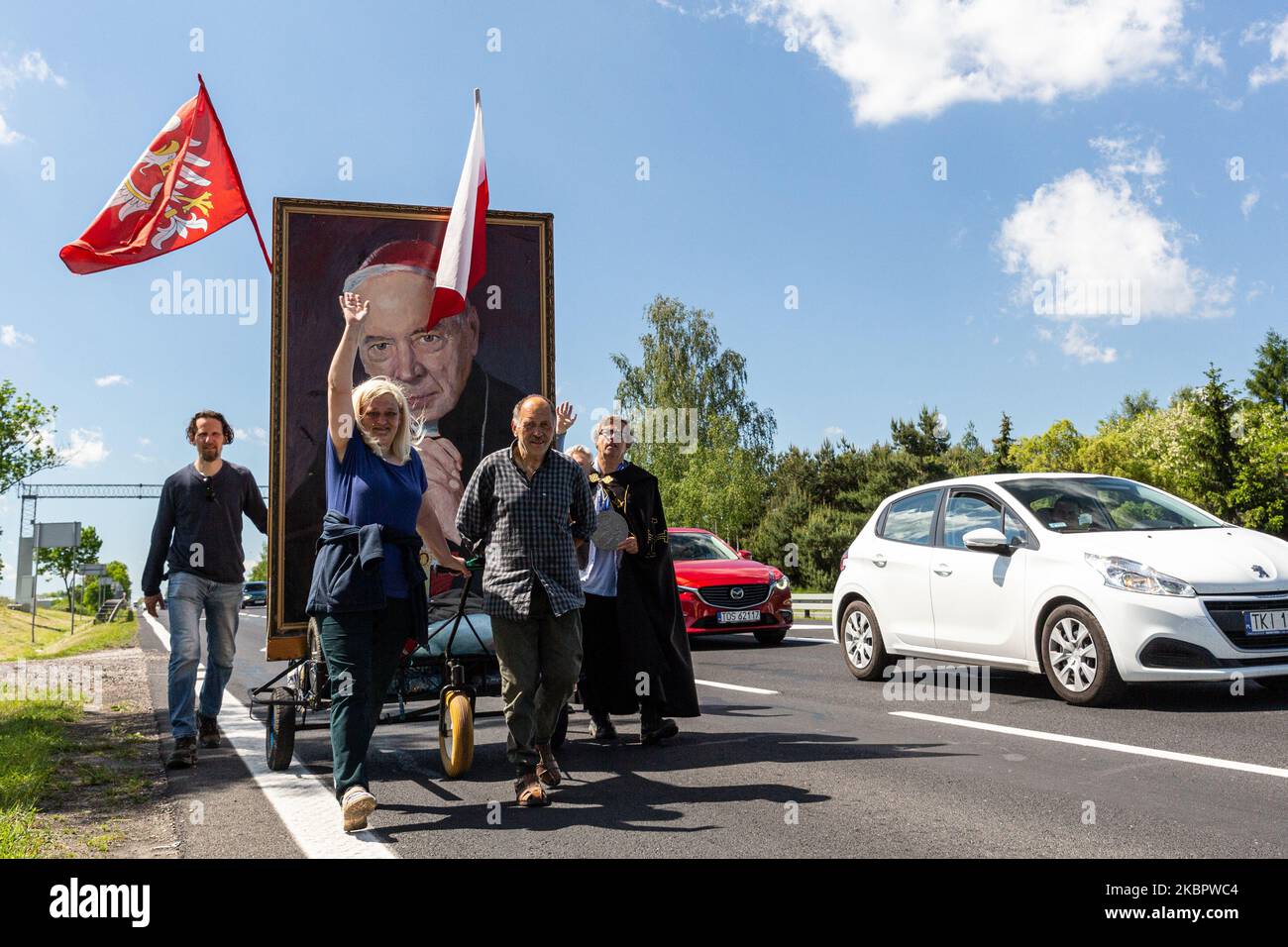 A group of faithful pushing a banner of a Polish cardinal Stefan Wyszynski walks on a highway leading to Warsaw from the south on June 6, 2020 in Warsaw, Poland. Cardinal Wyszynski, a very prominent figure of Polish opposition movement during communistic times, will gain an official status of blessed on June 7 in Warsaw. The group of faithful took days of precession to observe the ceremony in Warsaw. An interest in religion has increased in recent years. (Photo by Dominika Zarzycka/NurPhoto) Stock Photo