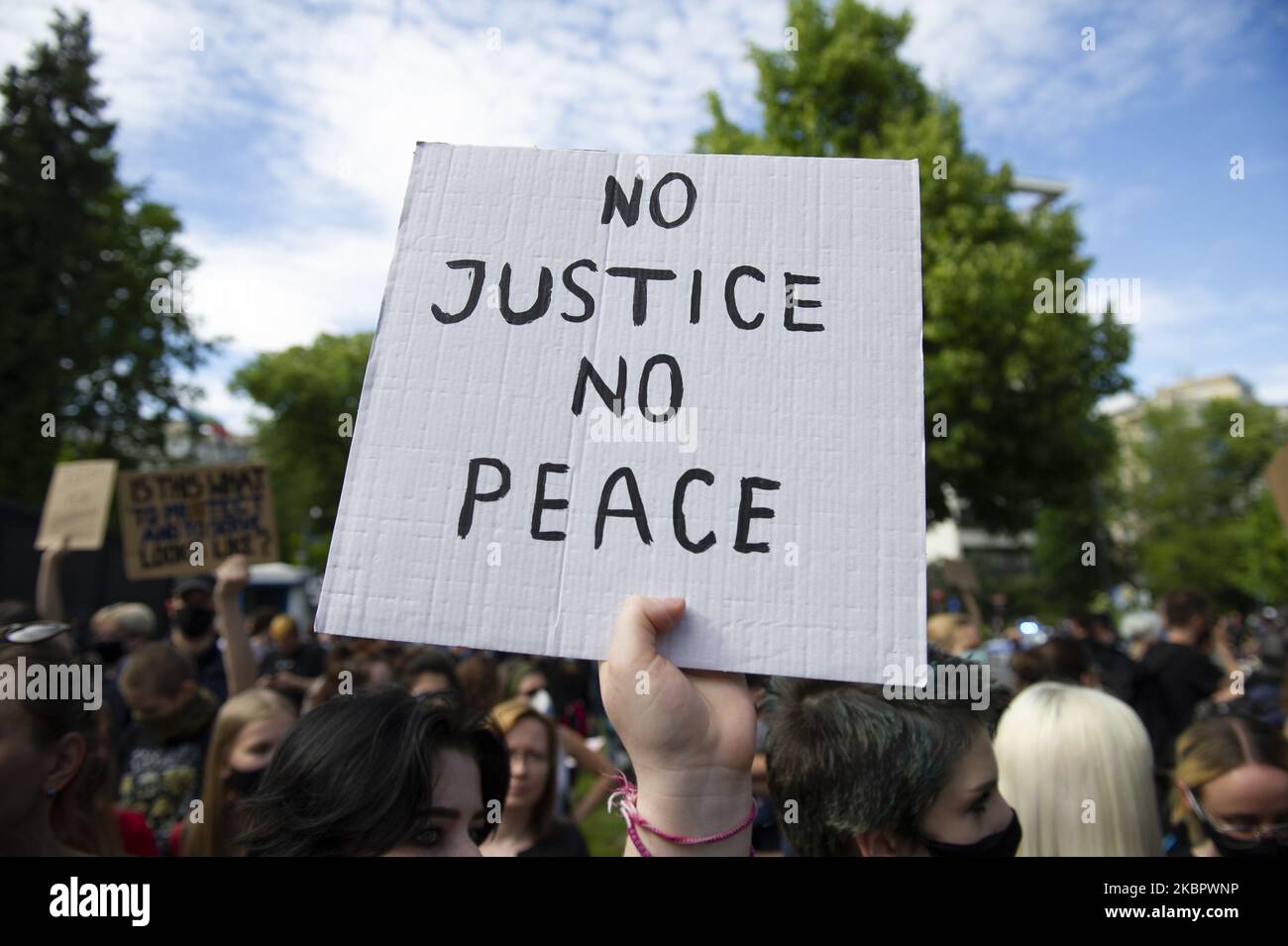 A placard is seen during a demonstration in front of the US embassy in Warsaw, Poland on June 6, 2020. People gathered in front of the US embassy in Warsaw in support of protesters in the US and to underline that abuse of power by police it is not only an US issue. George Floyd died on May 25, 2020 after Derek Chauvin, a police officer involved in his arrest in Minneapolis kneeled on his neck for almost 9 minutes. (Photo by Aleksander Kalka/NurPhoto) Stock Photo
