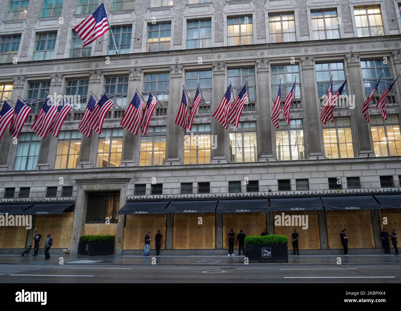 Famed Saks Fifth Avenue in New York City prepared against looting on June 5 by security guards with dogs and a chain-link fence over the boarded windows during George Floyd protests spread across big cities of the United States. (Photo by Selcuk Acar/NurPhoto) Stock Photo