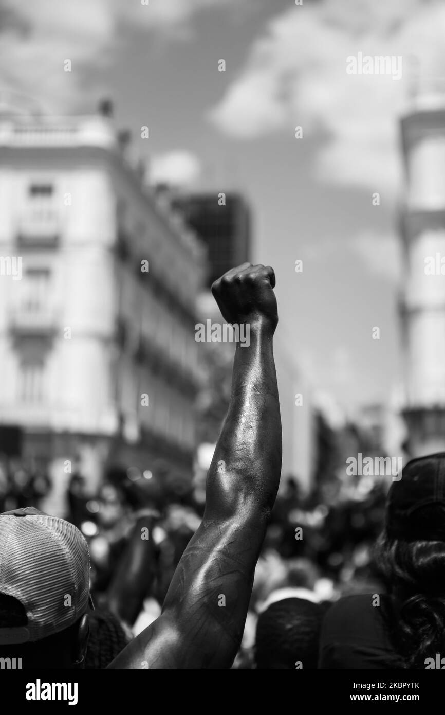 (EDITOR'S NOTE: Image was converted to black and white) A man rise his fist as a symbol of protest against racism and police brutality in a demo, in Madrid, Spain, on June 7, 2020. Hundreds of people gathered in Madrid to march against racism and police brutality following the wave of protest after the death of George Floyd in the United States. From the USA embassy to the centric Puerta del Sol, they marched shouting slogans and demanding true equality all over the country. (Photo by Guillermo Santos/NurPhoto) Stock Photo