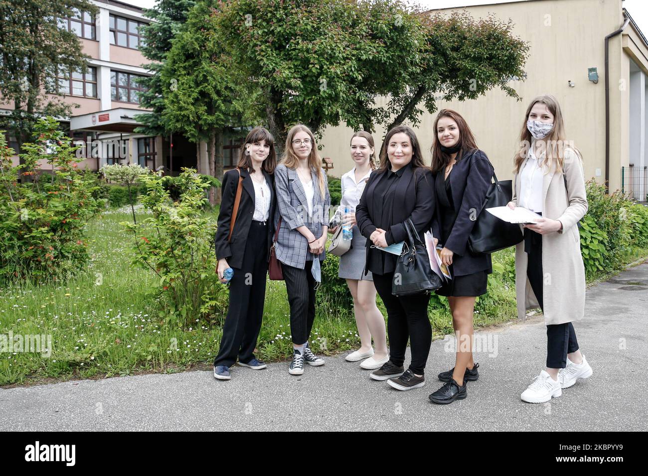 A group of young adults pose to be photographed before taking final graduation exam, called maturity exams in the First General Education High School (I Liceum Ogolnokrztalcace im. Stefana Zeromskiego) in Kielce, Poland on the June 8, 2020. It is the first day of the exams which will in total take about a month, it is the most important exam in Polsish schooling system. This year's exams take extra Coronacitus social distancing precautions. The 2020 graduates are particularly disadvantaged as schools were closed for three months and they had to prepare at home. (Photo by Dominika Zarzycka/NurP Stock Photo