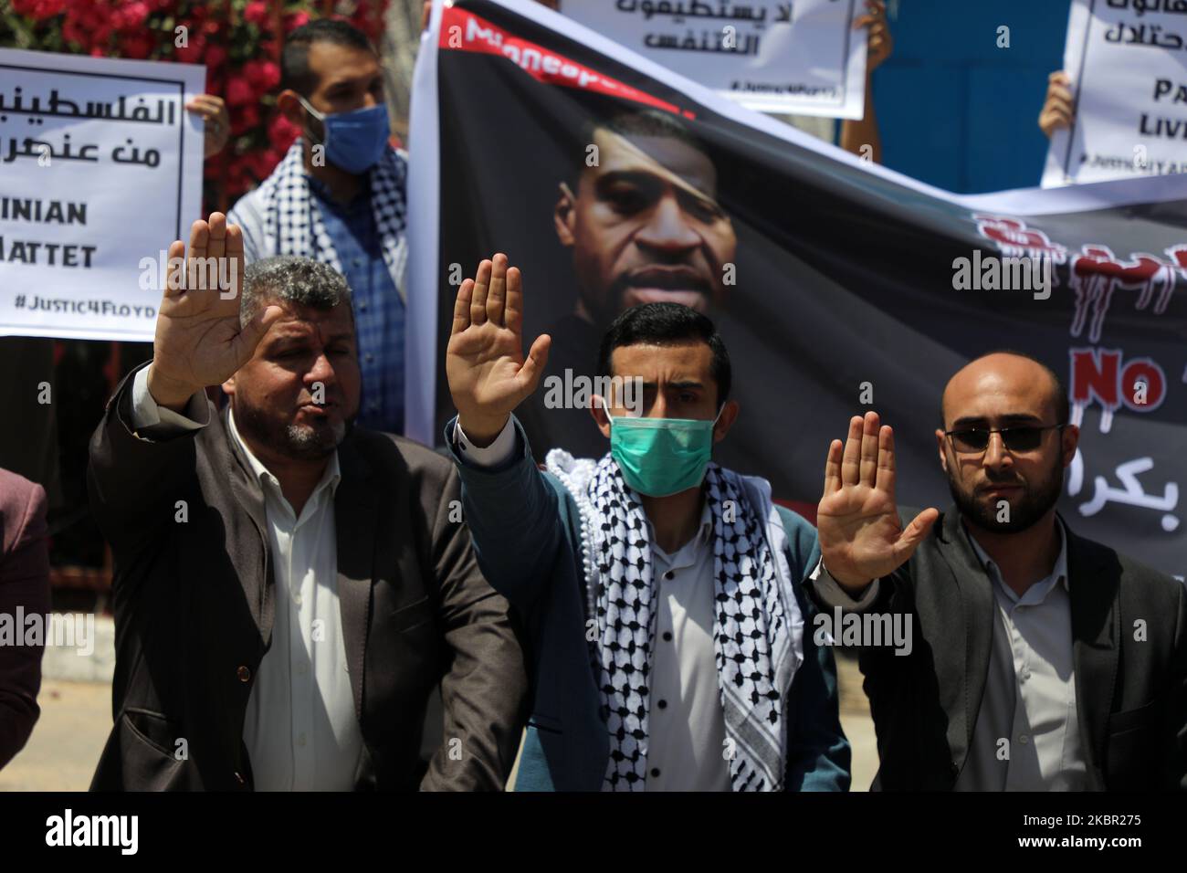 Palestinians gesture as others hold a banner with pictures of George Floyd, who died in Minneapolis police custody, and Iyad al-Halaq, an unarmed autistic Palestinian who was shot dead by Israeli police, during a protest against racial inequality, in Gaza City June 11, 2020. (Photo by Majdi Fathi/NurPhoto) Stock Photo