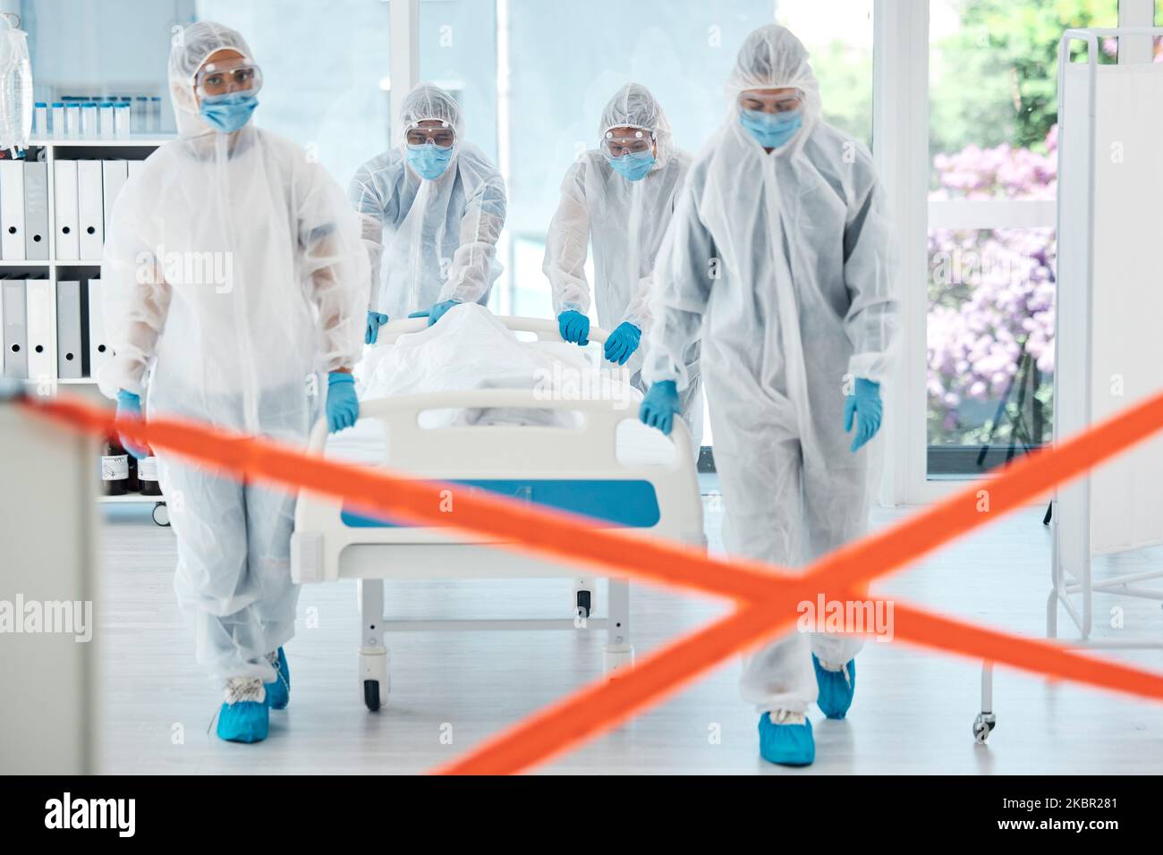 Healthcare doctor, covid patient or quarantine red tape zone with team in hazmat suit for