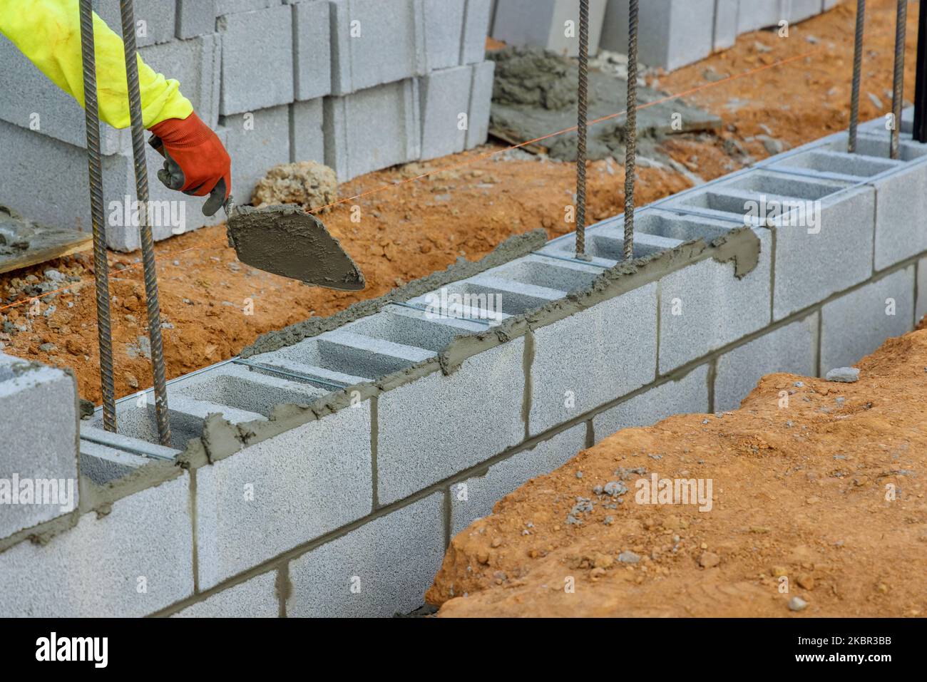 Bricklayer mason, is laying mounting for wall of concrete blocks that