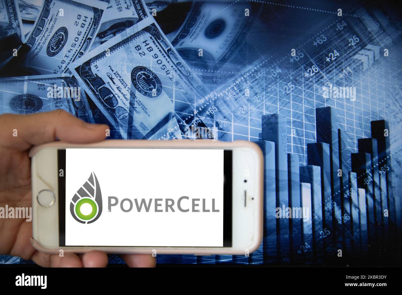 In this illustration is displayed on a smartphone's screen the company logo of PowerCell Sweden AB, which develops and produces hydrogen-driven fuel cell stacks and systems, is shown on the screen of a smartphone in front of a blue backdrop of the global stock markets and worldwide indices in Frankfurt, Germany, on 12th June, 2020. It is one of the global companies that manufactures hydrogen fuel cell stacks as well as other supporting facilities in the current alternative energy market. (Photo Illustration by Alexander Pohl/NurPhoto) Stock Photo