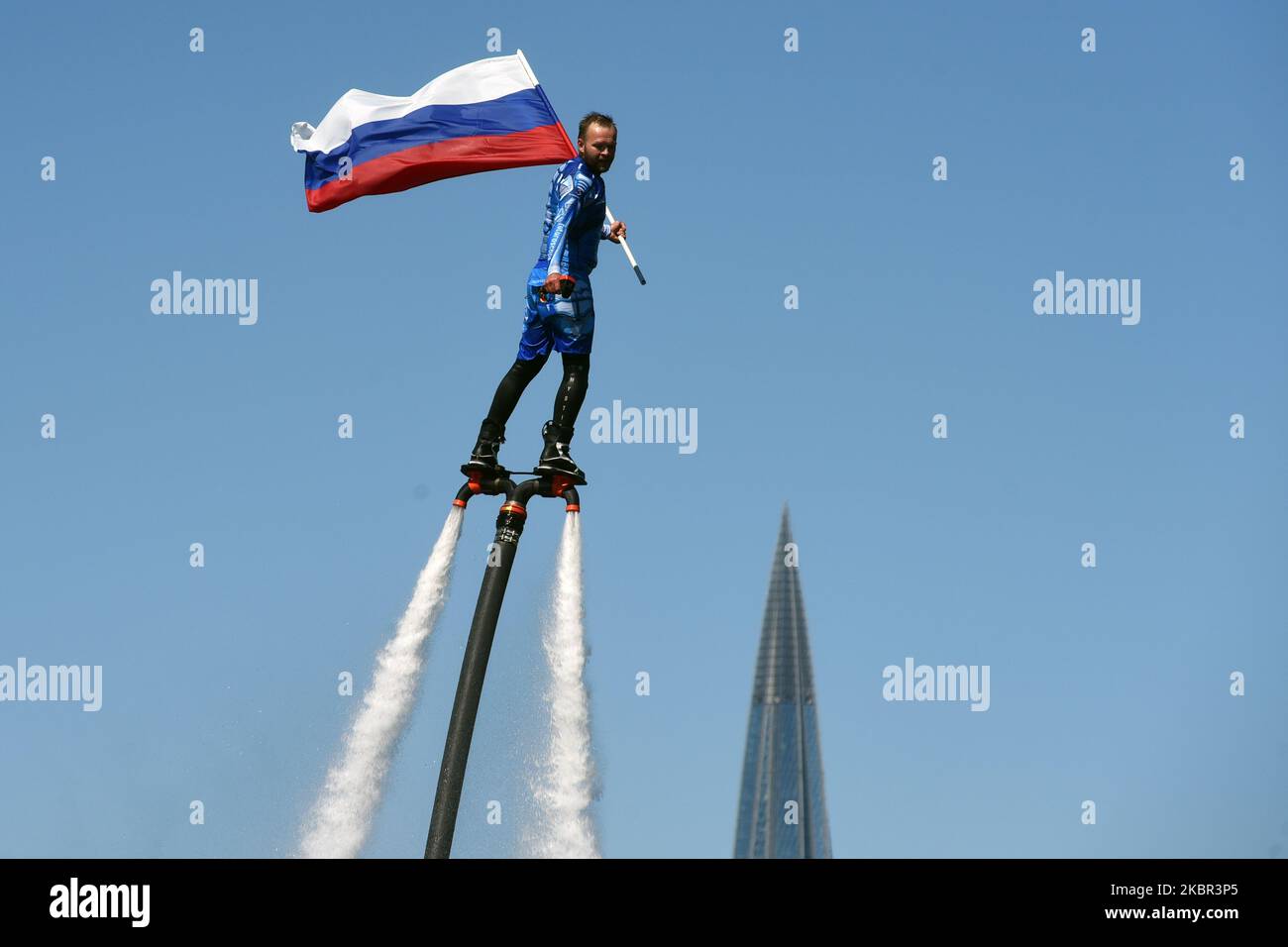 A member of the Russian hydroflight team performs holding the Russian national flag during the Day of Russia celebration on June 12, 2020 in St. Petersburg, Russia. (Photo by Sergey Nikolaev/NurPhoto) Stock Photo