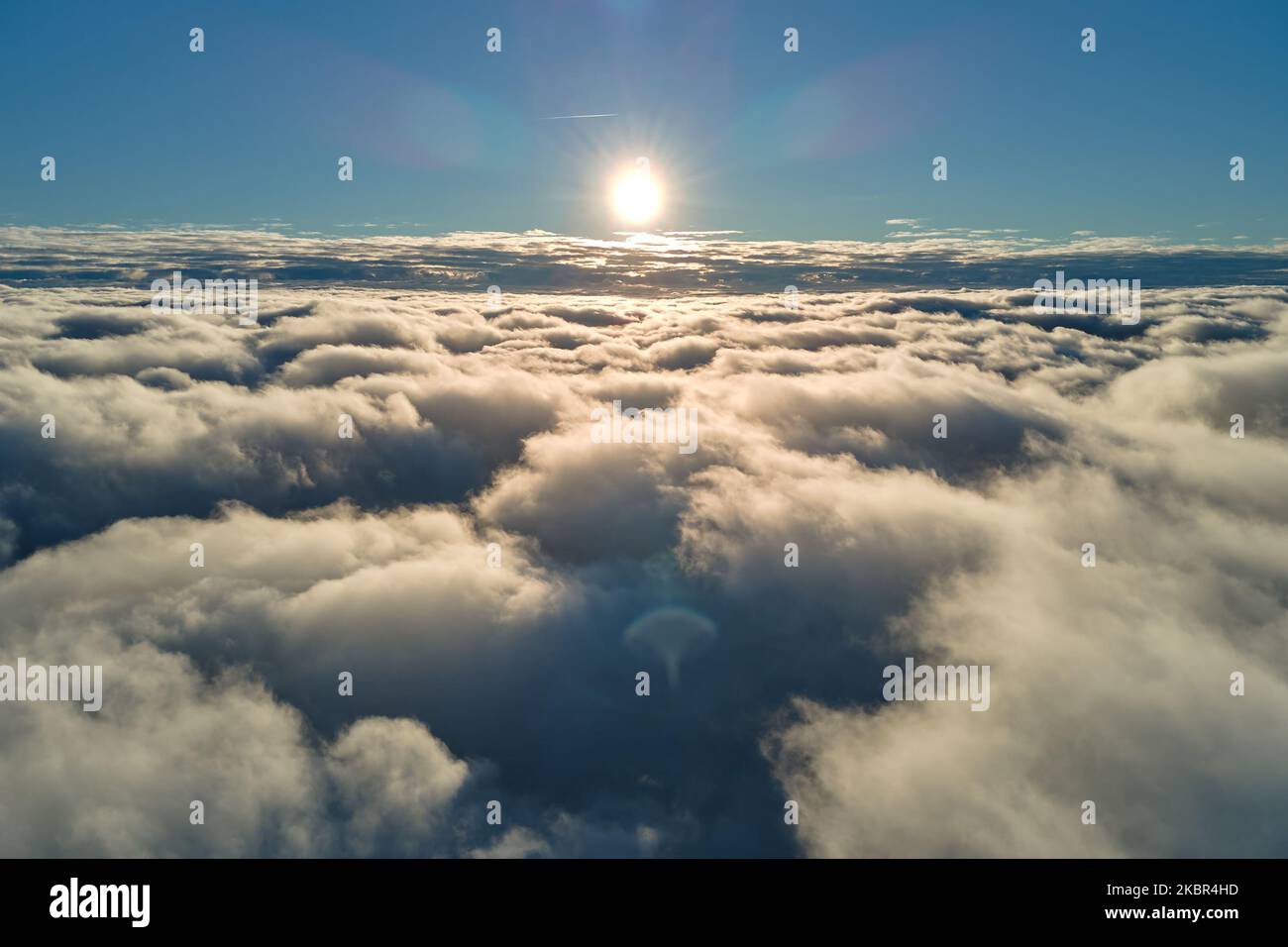 Aerial view from airplane window at high altitude of dense puffy ...