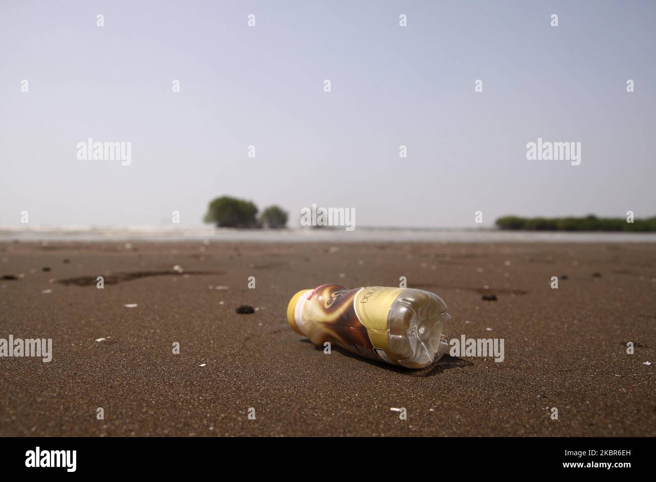 Plastic bottle waste are seen at the Pantai Bahagia, Muara Gembong sub-district, Bekasi regency, West Java province, on June 13, 2020. According to the research reports from the Indonesian Institute of Sciences (LIPI), released in 2018, the amount of plastic waste in the Indonesian sea reaches 100.000 - 400.000 tons per year, with an average coastline spread of arround 1.71 pieces per square meter with an average weight of 46.55 grams per square meter. While the highest average plastic waste was found on the coast of Sulawesi, reaching 2.11 pieces per square meter, followed by the Java coast w Stock Photo
