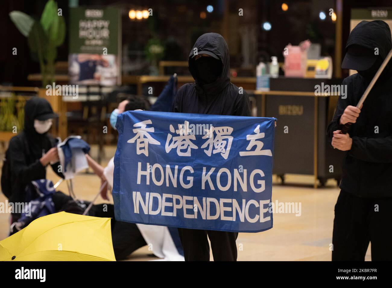 Pro Democracy supporters hold Hong Kong Independence signs and chant slogans such as 'One Nation, One Hong Kong' as members of the public queue for hours to pay respects on the one year anniversary of the death of Marco Leung Ling-Kit who fell to his death in 2019 on June 15, 2020 in Hong Kong, China.(Photo by Simon Jankowski/NurPhoto) Stock Photo