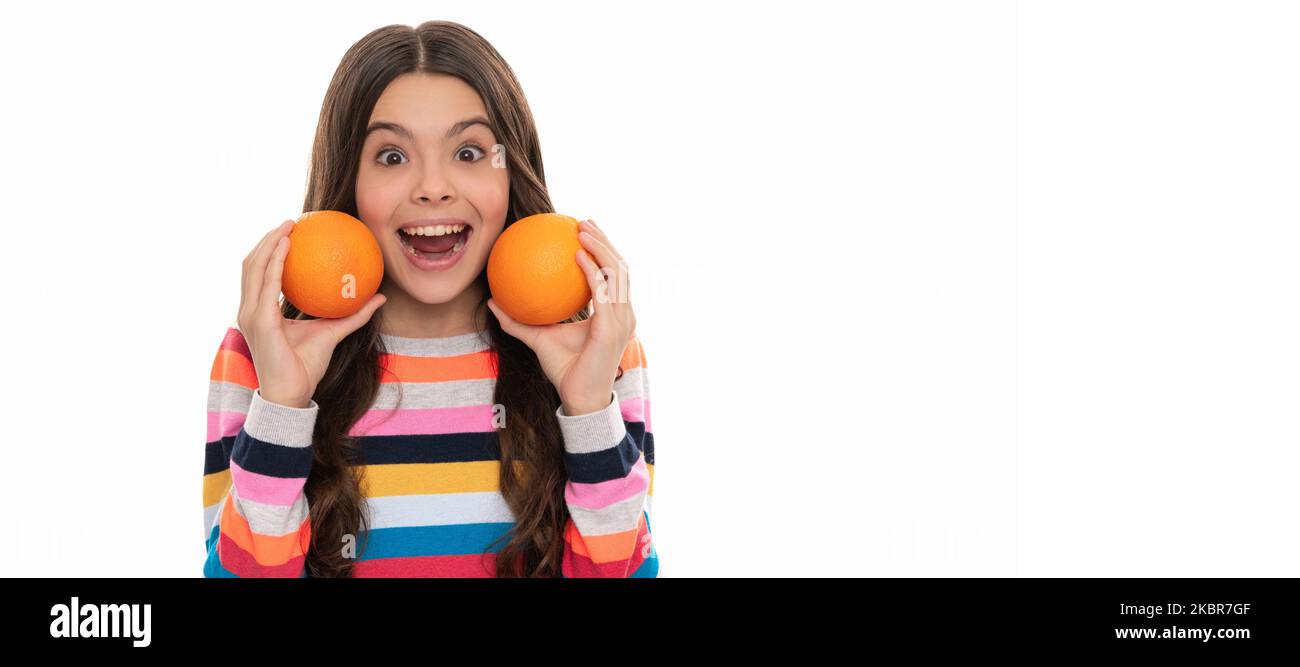 surprised kid in colorful sweater with orange fruit isolated on white, health. Child girl portrait with orange, horizontal poster. Banner header with Stock Photo