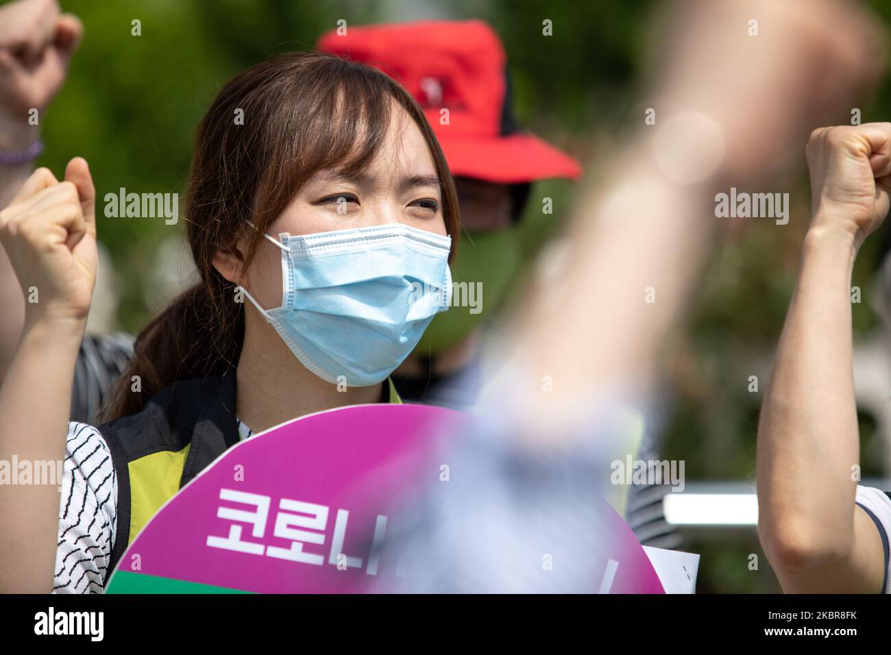 A union member of the National Health and Medical Industry Union holds a placard saying 'Corona-19 Out' during a protest at in front of the Yeouido National Assembly in Seoul, South Korea on June 16, 2020. They call for the condemnation of the Korean Medical Association against the expansion of medical personnel, expansion of medical school capacity, and promotion of public medical law legislation. (Photo by Chris Jung/NurPhoto) Stock Photo