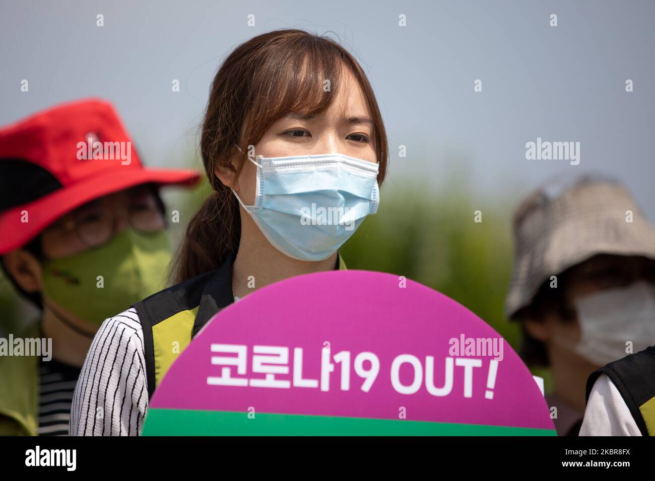 A union member of the National Health and Medical Industry Union holds a placard saying 'Corona-19 Out' during a protest at in front of the Yeouido National Assembly in Seoul, South Korea on June 16, 2020. They call for the condemnation of the Korean Medical Association against the expansion of medical personnel, expansion of medical school capacity, and promotion of public medical law legislation. (Photo by Chris Jung/NurPhoto) Stock Photo