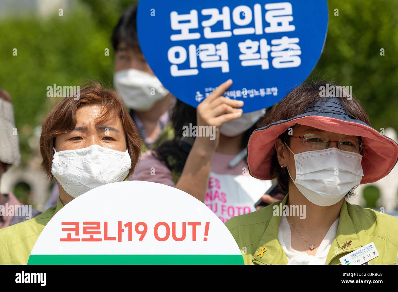 Union members of the National Health and Medical Industry Union holds a placard saying 'Corona-19 Out' during a protest at in front of the Yeouido National Assembly in Seoul, South Korea on June 16, 2020. They call for the condemnation of the Korean Medical Association against the expansion of medical personnel, expansion of medical school capacity, and promotion of public medical law legislation. (Photo by Chris Jung/NurPhoto) Stock Photo