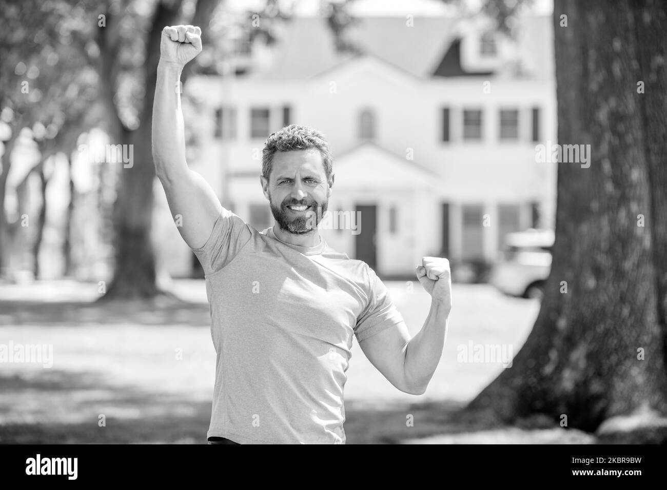 happy bearded man standing celebrating buying of house, home Stock Photo